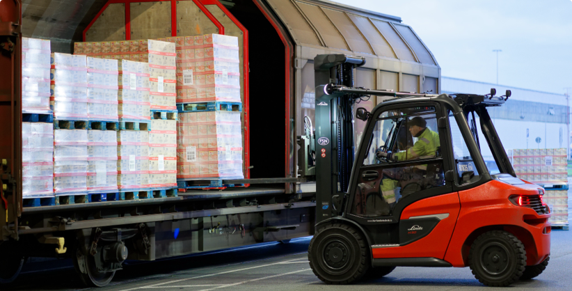 forklift loading a freight wagon
