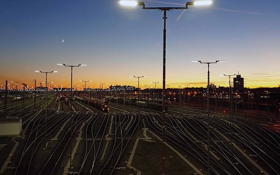 Ein Rangierbahnhof mit vielen Gleisen liegt im Dämmerlicht