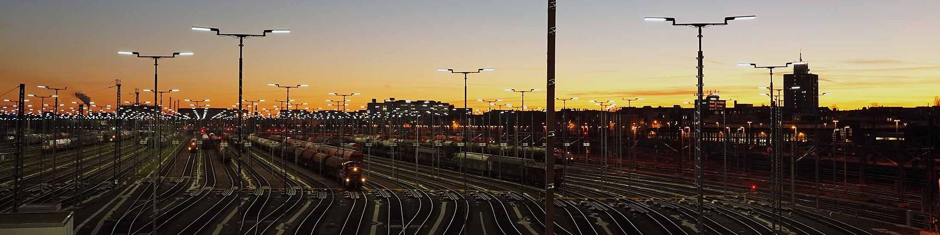 Ein Rangierbahnhof mit vielen Gleisen liegt im Dämmerlicht