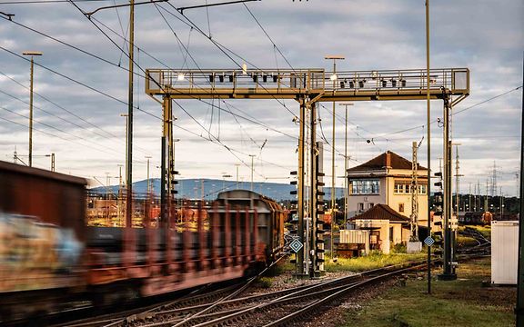 A freight car drives under a camera bridge with artificial intelligence for an inspection.