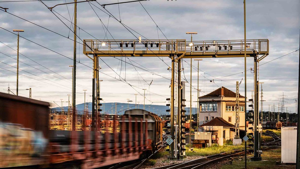A freight car drives under a camera bridge with artificial intelligence for an inspection.