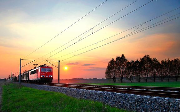 A goods train travelling at sunrise