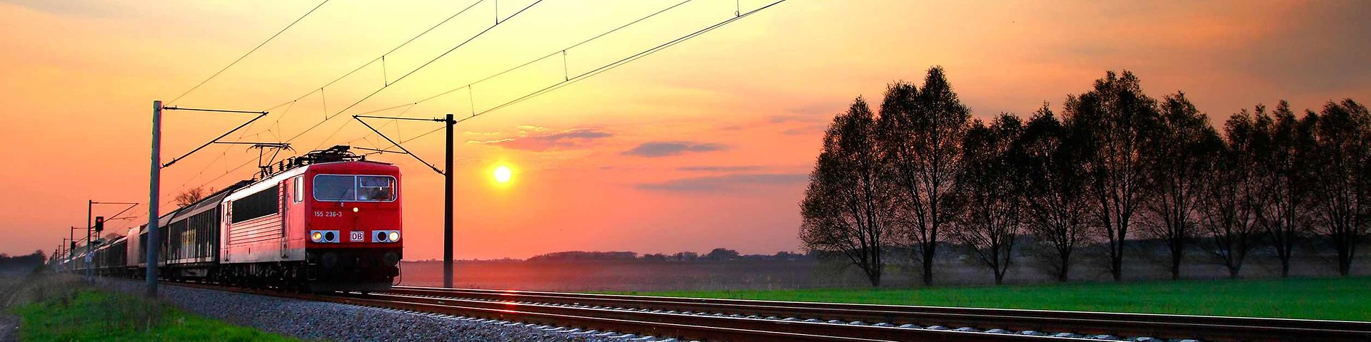 A goods train travelling at sunrise