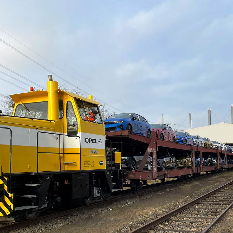 A locomotive with a car transport wagon.