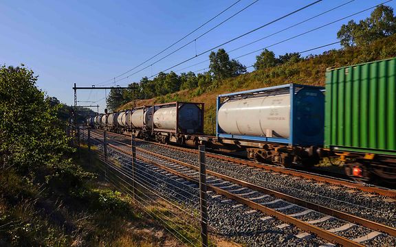 A goods train with tank containers passes by.