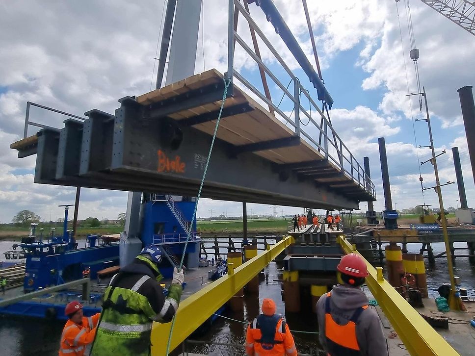 A section of the provisional bridge over the Hunte being put in place by a crane.