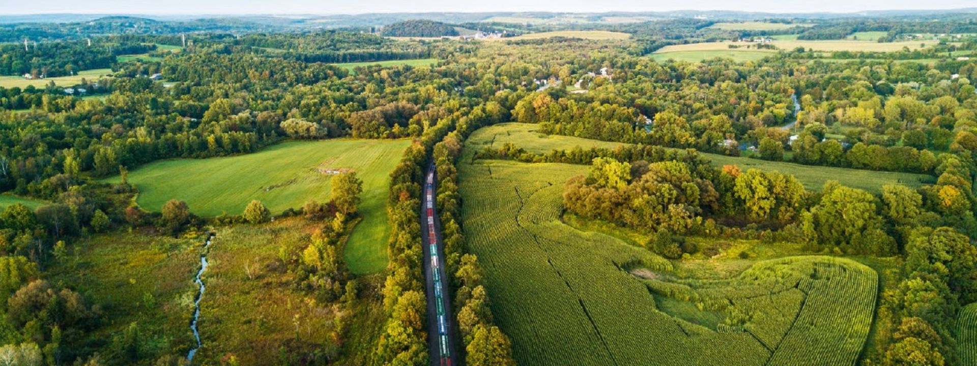 Train in green landscape from air perspective
