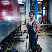 Young worker in train garage 