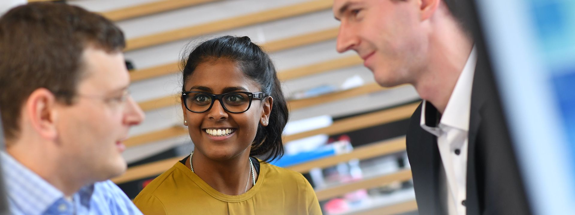 Three employees talking